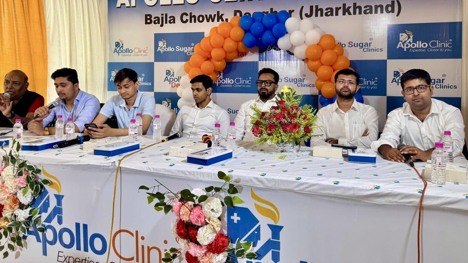 A panel seated behind microphones at a press meet for a clinic launch in Deoghar, Jharkhand