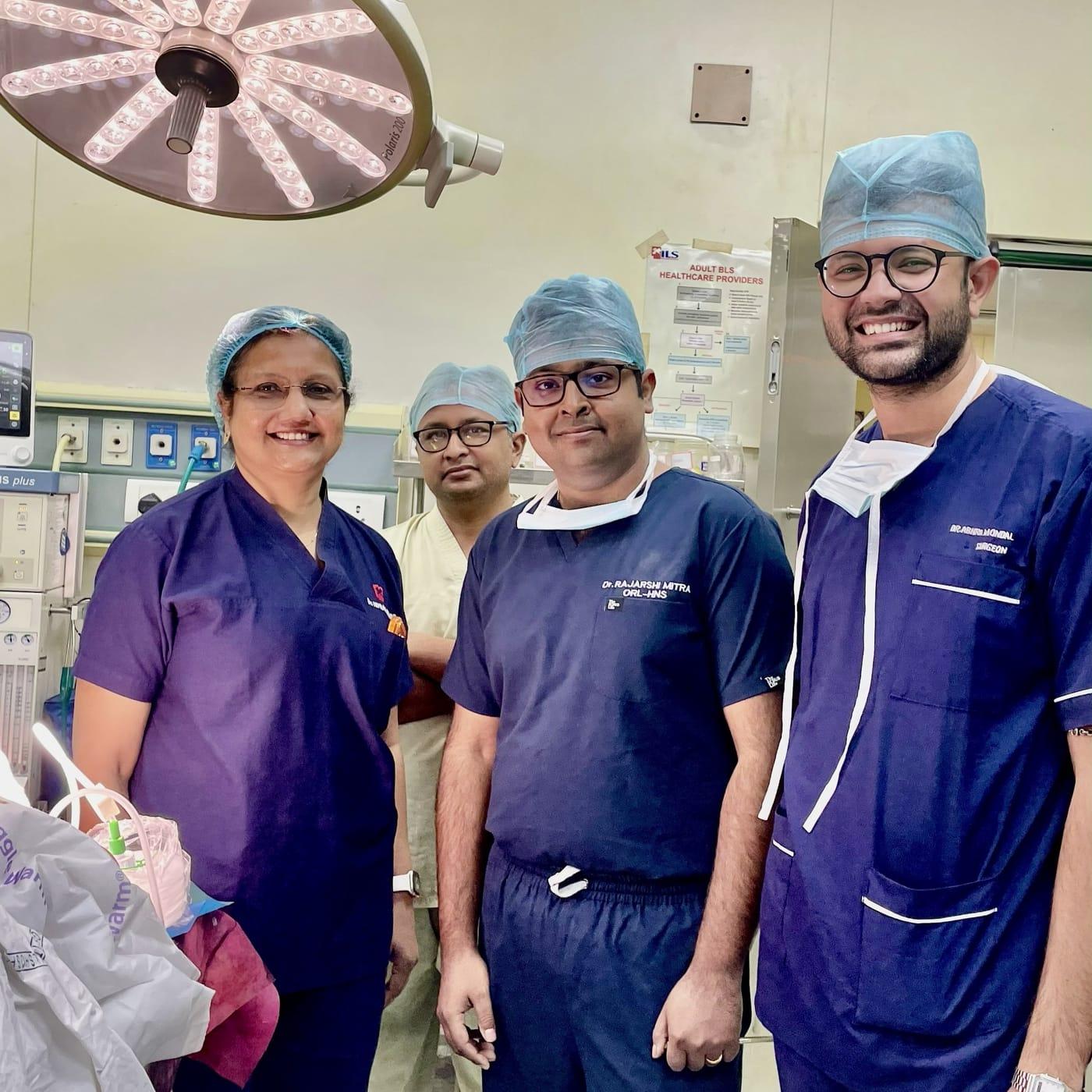 Dr. Rajarshi Mitra, Dr. Abhra Mondal and two colleagues in scrubs in the operating theatre