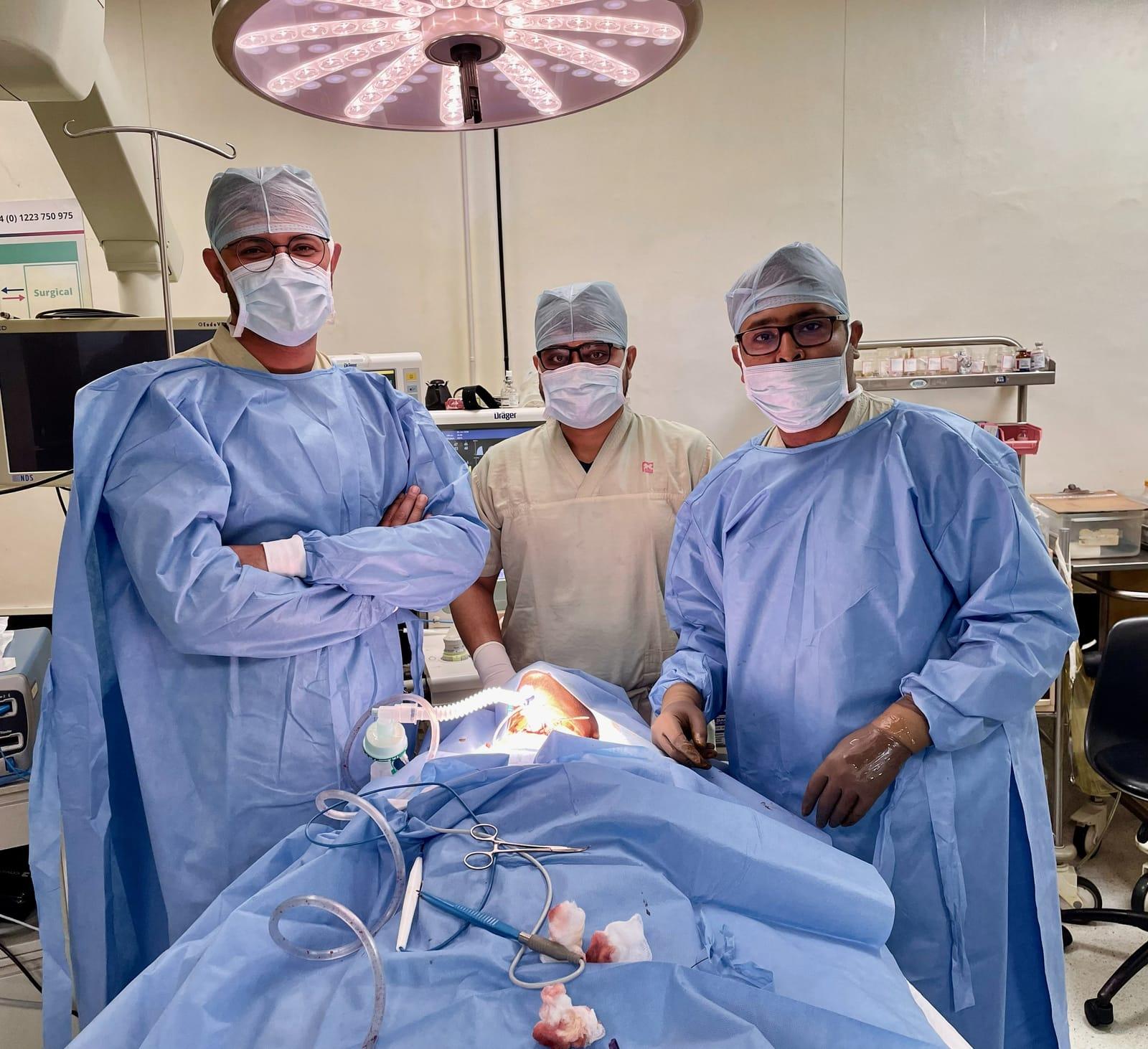 Three Krancer surgeons in gowns and masks in the operating theatre